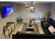 Living room boasts leather seating, tile floors, and contemporary decor with a large TV at 2377 W Hazelwood St, Phoenix, AZ 85015