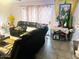 Cozy living room featuring leather furniture, a decorative rug, and bright natural light at 2377 W Hazelwood St, Phoenix, AZ 85015