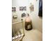 Interior stairway with a vintage doll and collage of Gathering photographs at 2377 W Hazelwood St, Phoenix, AZ 85015