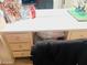 A vanity with neutral-colored cabinets, a white top, and a mirror, partially blocked by a black sweatshirt at 2377 W Hazelwood St, Phoenix, AZ 85015