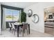 Chic dining room with a view, featuring a modern table and chair set under natural light at 24105 W Flores Dr, Buckeye, AZ 85326