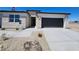 Attractive single-story home with a two-car garage and stone accents at 24105 W Flores Dr, Buckeye, AZ 85326