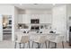 Contemporary kitchen showcasing a quartz island with seating and state-of-the-art appliances at 24105 W Flores Dr, Buckeye, AZ 85326