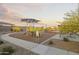 Community playground with slide, picnic tables, walking path and desert landscaping at 24105 W Flores Dr, Buckeye, AZ 85326