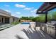 Outdoor kitchen with BBQ, poolside, and manicured backyard, ideal for entertaining and enjoying the outdoors at 2821 E Cashman Dr, Phoenix, AZ 85050