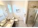 Well-lit bathroom with granite countertop, neutral tile, framed mirror and glass enclosed shower at 2821 E Cashman Dr, Phoenix, AZ 85050