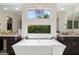 Bright bathroom featuring a soaking tub under a window at 2821 E Cashman Dr, Phoenix, AZ 85050