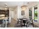 Bright dining area with a modern chandelier and sleek black dining set near the kitchen at 2821 E Cashman Dr, Phoenix, AZ 85050