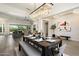 Elegant dining room features an oversized chandelier, modern art and adjacent views of the living room at 2821 E Cashman Dr, Phoenix, AZ 85050
