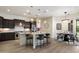 Bright eat-in kitchen features dark wood cabinetry, stainless appliances, pendant lights, and tile backsplash at 2821 E Cashman Dr, Phoenix, AZ 85050