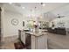 Open-concept kitchen with stainless steel appliances, a large island, and views of the living area at 2821 E Cashman Dr, Phoenix, AZ 85050