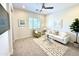 Bright living room featuring a modern ceiling fan, comfortable seating, and stylish decor at 2821 E Cashman Dr, Phoenix, AZ 85050