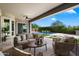 Inviting covered patio with stylish furniture, overlooking a pristine pool and landscaped backyard at 2821 E Cashman Dr, Phoenix, AZ 85050