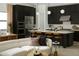 Open-concept kitchen and living area featuring a kitchen island with seating and stainless steel appliances at 2916 E Sells Dr, Phoenix, AZ 85016