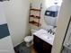 Bathroom features a vanity with sink, toilet, decorative shelves, and ample lighting at 2927 N Oregon St # 7, Chandler, AZ 85225