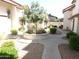 Landscaped courtyard featuring a concrete walkway with a central tree and garden bed at 2927 N Oregon St # 7, Chandler, AZ 85225