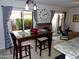 Dining room area adjacent to sliding glass doors with a wooden table set for four at 2927 N Oregon St # 7, Chandler, AZ 85225