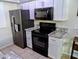 Updated kitchen showcasing stainless steel appliances, sleek cabinetry, and stone countertops at 2927 N Oregon St # 7, Chandler, AZ 85225