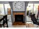 Living room including a decorative fireplace flanked by sliding glass doors with backyard views at 2927 N Oregon St # 7, Chandler, AZ 85225
