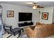 Comfortable living space featuring a ceiling fan, modern furnishings, and a large television at 2927 N Oregon St # 7, Chandler, AZ 85225
