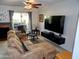 Relaxing living room featuring a ceiling fan, sliding glass doors, and a comfortable sectional sofa at 2927 N Oregon St # 7, Chandler, AZ 85225