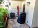 Outdoor patio space featuring potted plants, AC unit, covered grill, and stone flooring at 2927 N Oregon St # 7, Chandler, AZ 85225