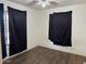 Cozy bedroom featuring wood look floors, ceiling fan and large windows with light filtering curtains at 3112 W Taylor St, Phoenix, AZ 85009