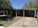 Single story home with drought tolerant landscaping and long covered parking area at 3112 W Taylor St, Phoenix, AZ 85009