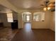 Spacious room showcasing tile floors, neutral paint, ceiling fan and an open concept to the kitchen at 3112 W Taylor St, Phoenix, AZ 85009
