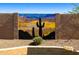 Backyard block wall featuring desert-themed custom artwork at 3538 E Squawbush Pl, Phoenix, AZ 85044