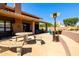 Spacious backyard with a covered patio, lounge areas, and mature trees at 3538 E Squawbush Pl, Phoenix, AZ 85044