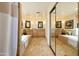 Spacious bathroom with dual sinks, mirrors, and soaking tub, features tiled floors and light neutral walls at 3538 E Squawbush Pl, Phoenix, AZ 85044