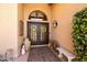 Double front doors featuring decorative wreaths and a lush, well-maintained landscape at 3538 E Squawbush Pl, Phoenix, AZ 85044