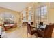 Bright living room featuring a dining area, fireplace, built-ins and large windows at 3538 E Squawbush Pl, Phoenix, AZ 85044