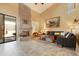 Spacious living room with fireplace, tile flooring, and sliding glass door to the backyard at 3538 E Squawbush Pl, Phoenix, AZ 85044