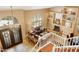 Bright view of the living room highlighting large windows, fireplace, and staircase at 3538 E Squawbush Pl, Phoenix, AZ 85044