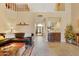 Open-concept living room featuring a bar area, tile flooring, and a view to the entryway at 3538 E Squawbush Pl, Phoenix, AZ 85044