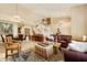Spacious living room with a fireplace, grand staircase and ample seating at 3538 E Squawbush Pl, Phoenix, AZ 85044