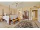 Bright main bedroom featuring a four-poster bed and private ensuite bathroom at 3538 E Squawbush Pl, Phoenix, AZ 85044