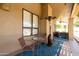 Inviting covered patio with a heater, seating, and view of the pool at 3538 E Squawbush Pl, Phoenix, AZ 85044