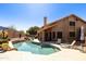 Sparkling backyard pool with desert landscaping, a covered patio, and comfortable lounging furniture offers ultimate relaxation at 3538 E Squawbush Pl, Phoenix, AZ 85044