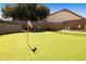 Private putting green in the backyard, perfect for golf enthusiasts at 3538 E Squawbush Pl, Phoenix, AZ 85044