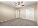 Bedroom featuring a ceiling fan, carpet, closet and ensuite bathroom at 3632 W Mariposa St, Phoenix, AZ 85019