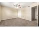 Inviting bedroom featuring a ceiling fan, closet space, and soft carpeting for a comfortable retreat at 3632 W Mariposa St, Phoenix, AZ 85019