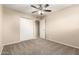 Comfortable bedroom featuring a ceiling fan, carpet, and a closet at 3632 W Mariposa St, Phoenix, AZ 85019