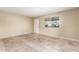 Spacious room featuring tile flooring, a window with blinds, and a neutral color palette at 3632 W Mariposa St, Phoenix, AZ 85019