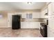 Bright kitchen with white cabinets, black appliances, tile floor, and granite countertops at 3632 W Mariposa St, Phoenix, AZ 85019