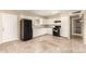Kitchen featuring white cabinets, granite countertops, and black appliances complemented by tile flooring at 3632 W Mariposa St, Phoenix, AZ 85019