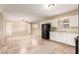 The well-lit kitchen has granite countertops, white cabinets, tile floors, and black appliances at 3632 W Mariposa St, Phoenix, AZ 85019