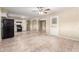 Wide angle of tile floors, arched doorways, and black appliances creating an open and airy living space at 3632 W Mariposa St, Phoenix, AZ 85019